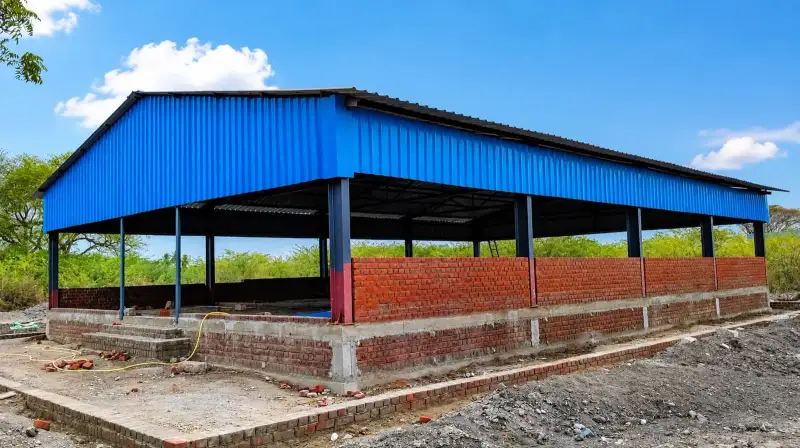 Animal shed under construction with blue roofing sheets and brick half-walls
