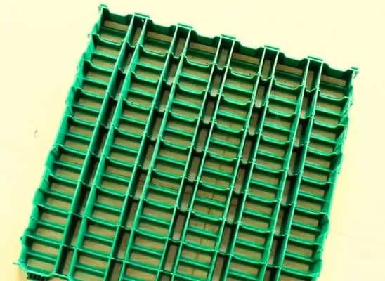 Close-up of KPN's in-house green slatted floor mat for animal sheds