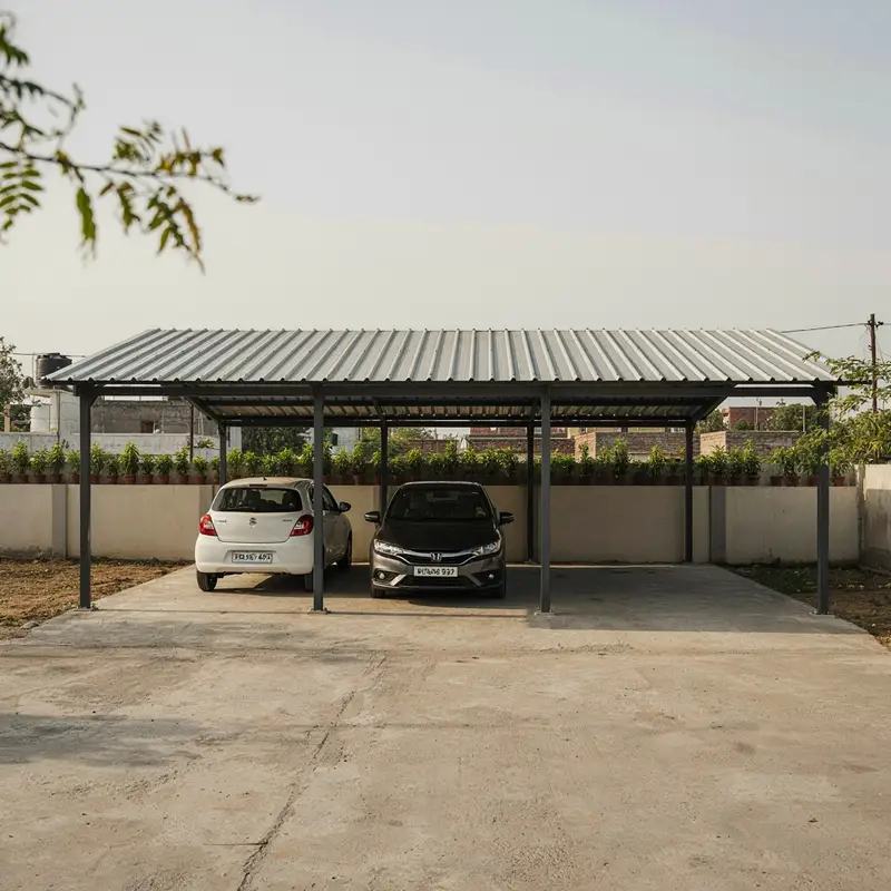 Small car parking shed sheltering two cars against a boundary wall