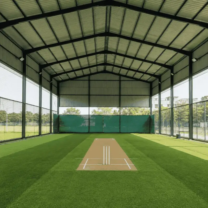 Empty covered cricket practice pitch with artificial turf