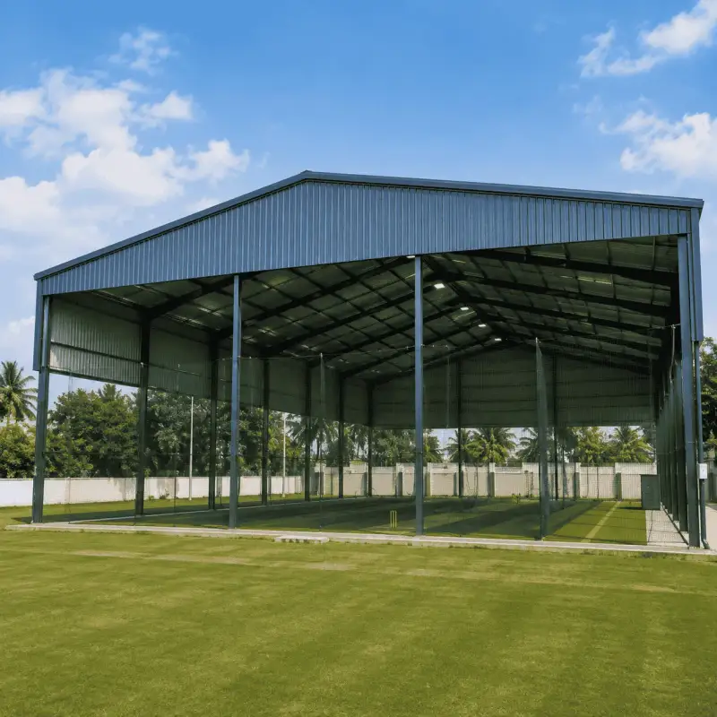 Exterior of a covered cricket turf shed beside a green field