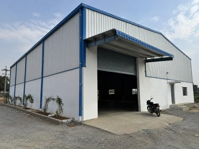 Factory shed with a roller shutter entrance and a parked motorbike
