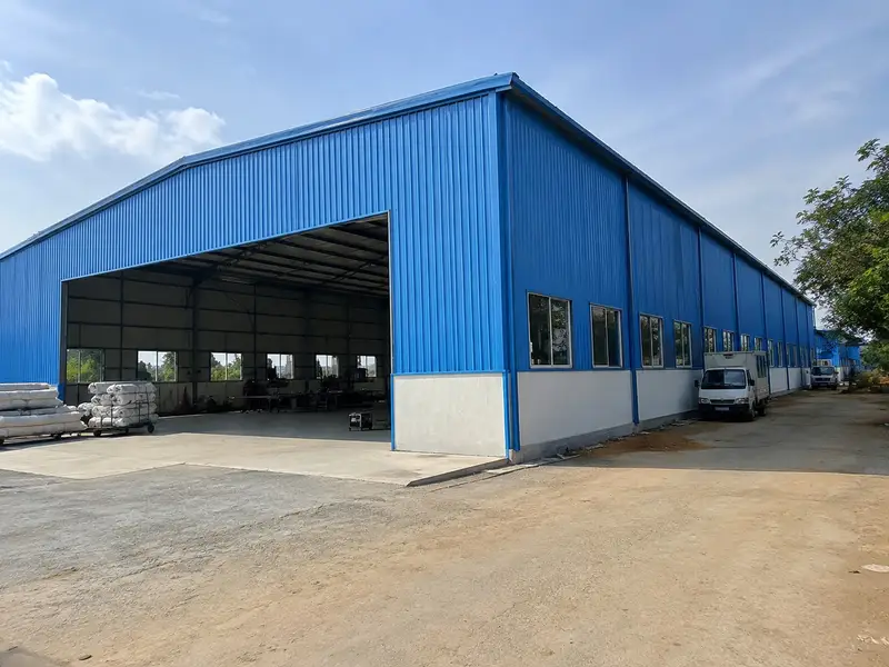 Garment factory shed interior with rows of sewing workstations